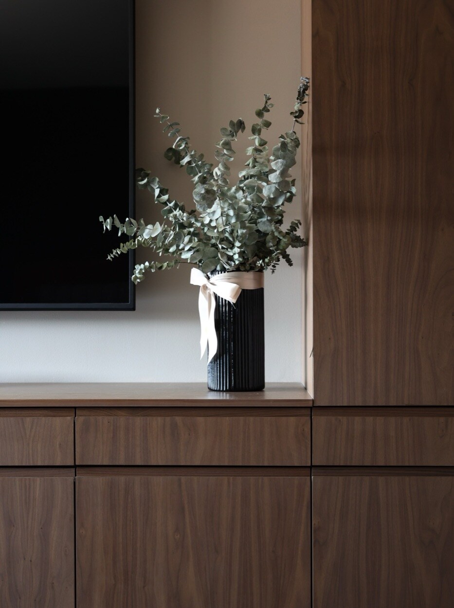 Hand-finished walnut casework · matched grain, integrated reveals